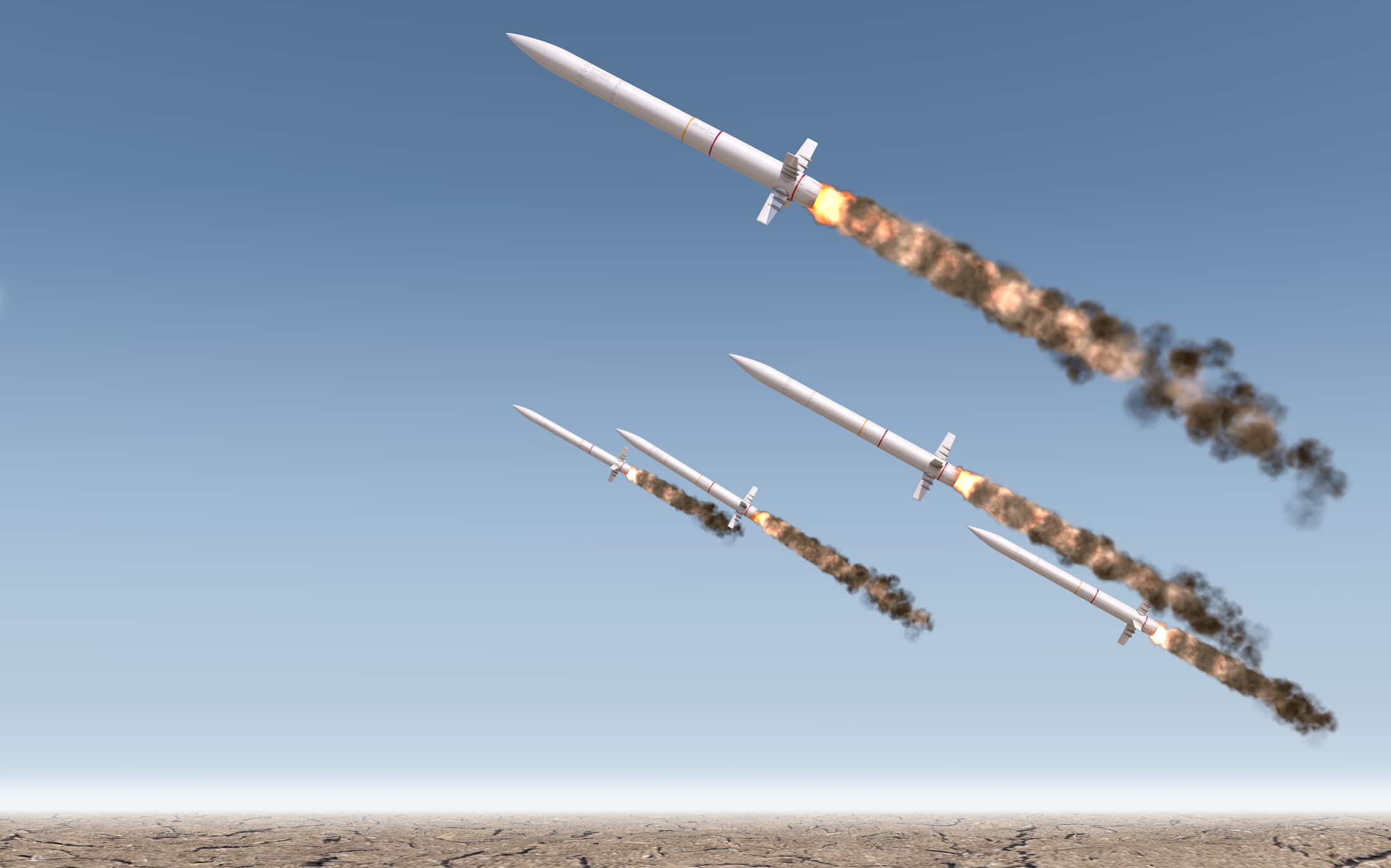 A row of intercontinental ballistic missiles launching in a desert
